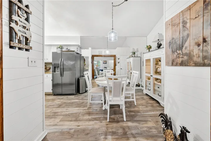 This kitchen and dining area features a bright and inviting atmosphere with vaulted ceilings.