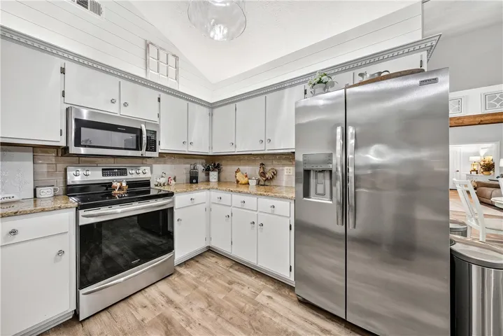 This inviting kitchen showcases modern appliances and ample storage for seamless culinary endeavors.