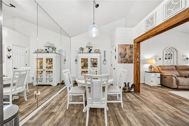 This bright dining area features high ceilings, creating an airy and inviting atmosphere.