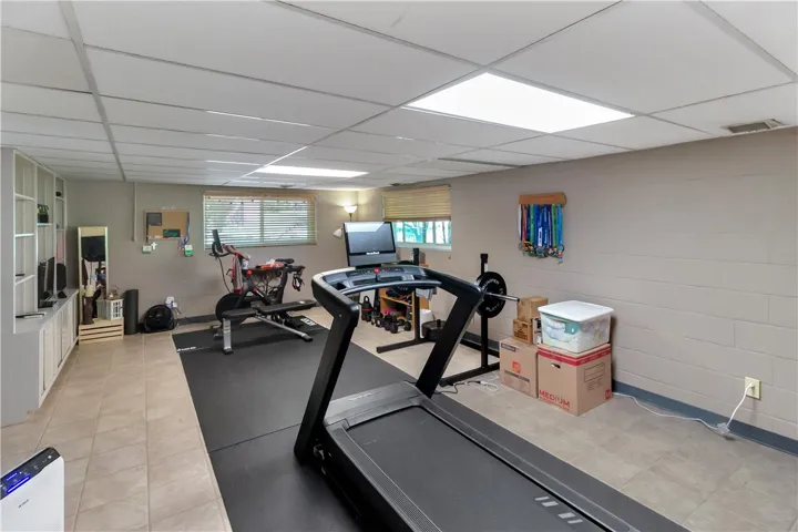 This dedicated exercise room features durable tile flooring, perfect for your fitness regimen.