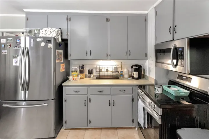 This bright kitchen features durable tile flooring, providing both style and practicality.