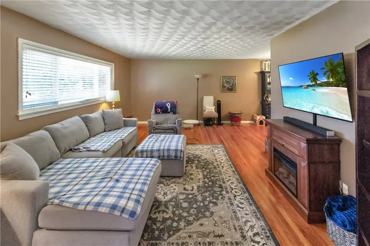 This living room features gleaming hardwood floors and ample natural light.