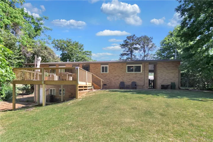 This charming brick home features a spacious deck, perfect for outdoor living and entertaining.