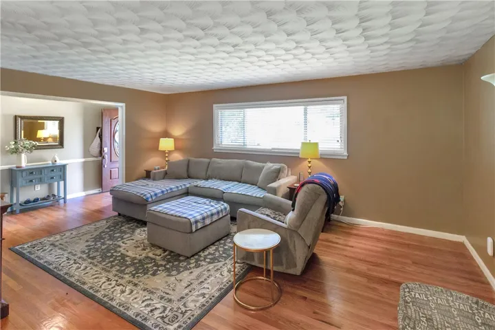 Warm and inviting living space with rich hardwood flooring awaits your personal touch.