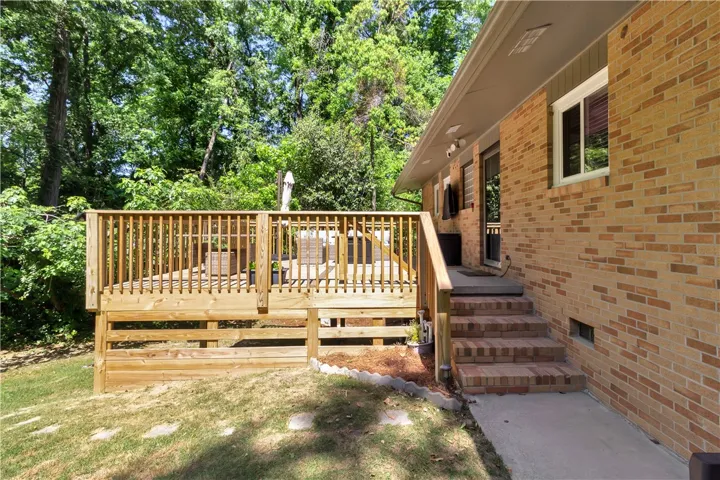 This charming home features a lovely deck, perfect for outdoor entertaining and enjoying the surrounding greenery.
