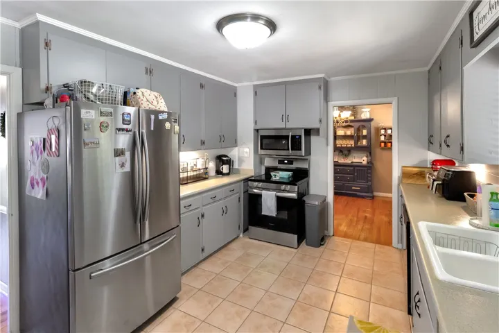 This bright kitchen features modern appliances and ample cabinet space, perfect for culinary endeavors.