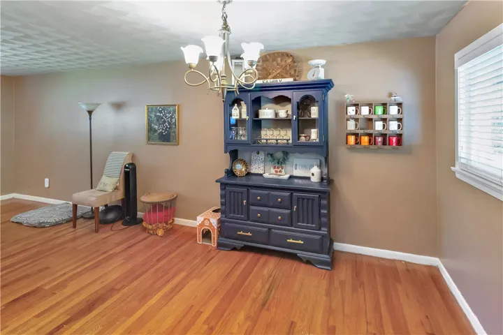 This inviting space features lustrous wood floors and natural light, creating a warm ambiance.