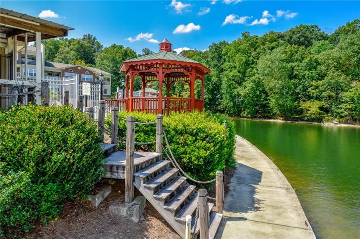This serene lakeside property features a charming gazebo and convenient steps to the water's edge.