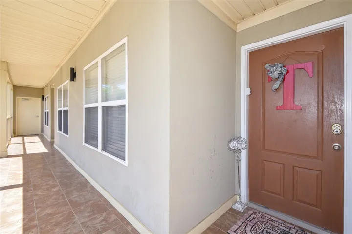 This charming entry features a tiled walkway and a welcoming door.