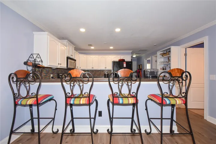 This spacious kitchen offers ample cabinet storage and a convenient breakfast bar.