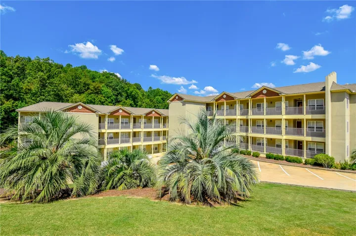 This spacious apartment building features private balconies, ample parking, and lush landscaping for a comfortable lifestyle.