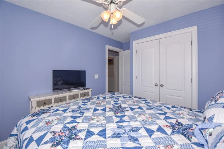 This cozy bedroom features a practical layout with direct access to a closet.