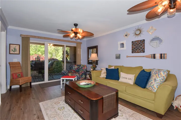 This inviting living area boasts rich hardwood flooring and convenient sliding glass doors.