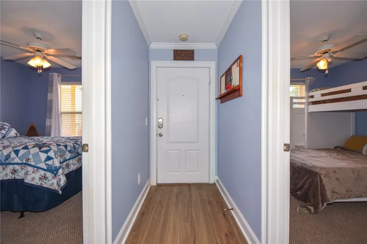 This entry foyer opens to cozy bedrooms, showcasing a harmonious blend of comfort and style.