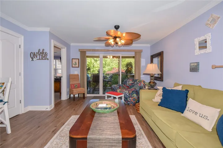 This inviting living area boasts rich hardwood floors and a spacious patio for seamless indoor-outdoor living.