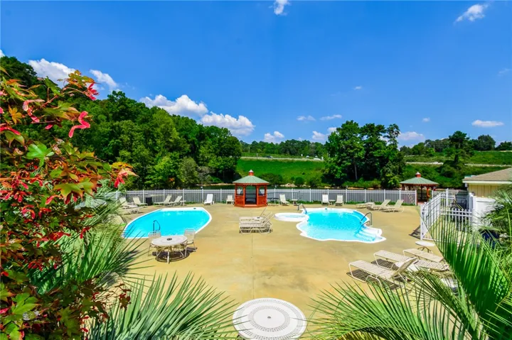 Two refreshing pools and a gazebo create an inviting outdoor oasis for relaxation and recreation.