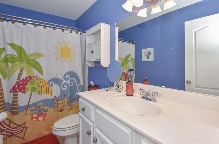 This vibrant bathroom offers a cheerful and bright space with ample counter space.
