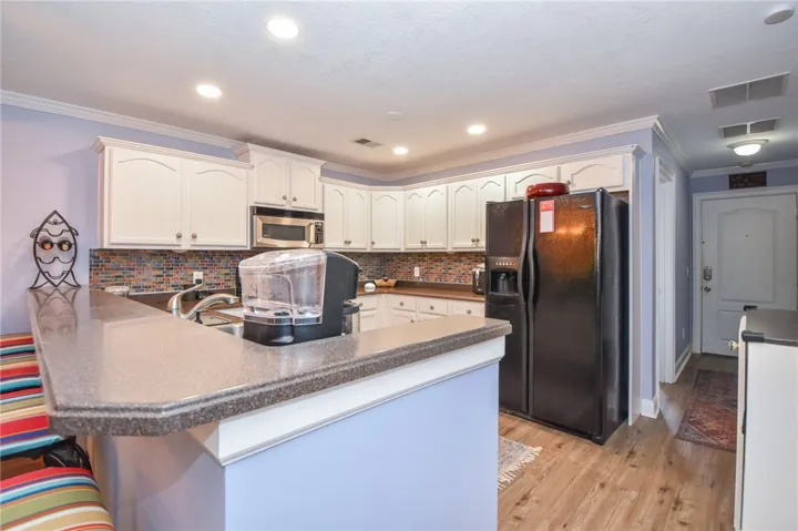 This kitchen showcases ample cabinet space, modern appliances, and convenient open-concept living.