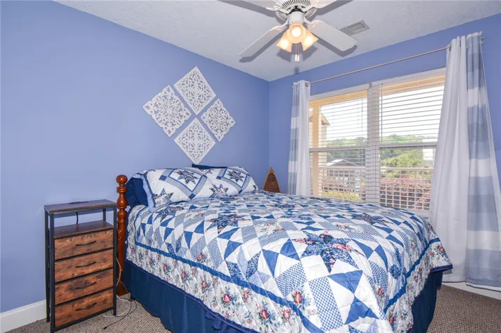 This cozy bedroom offers a tranquil retreat with ample natural light.