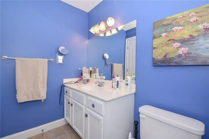 This bright bathroom features a spacious vanity with ample counter space and storage.