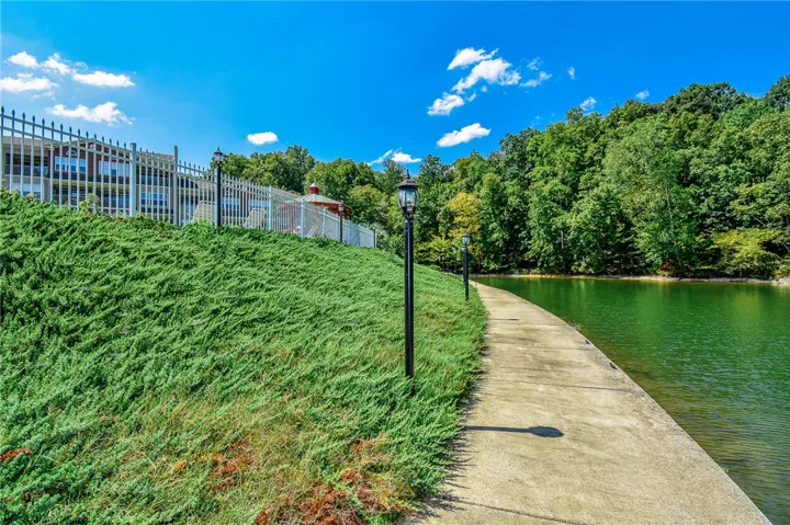 This scenic lakeside pathway offers a serene outdoor escape with lush greenery and tranquil waters.