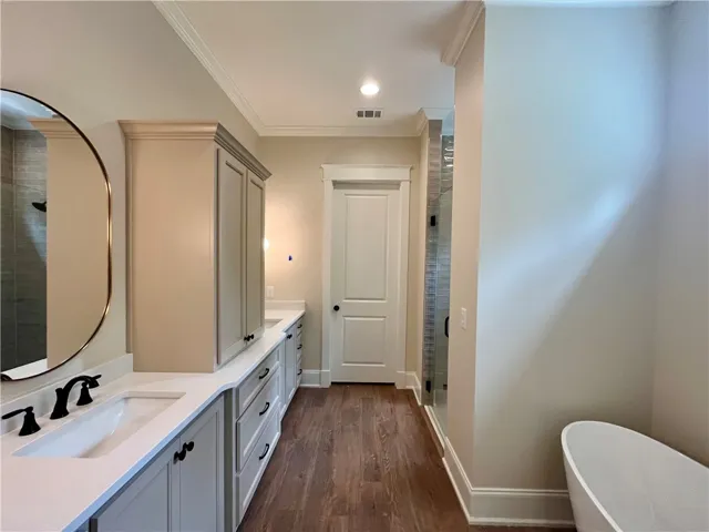 This spacious Primary bathroom offers elegant dual vanities and a relaxing soaking tub.
