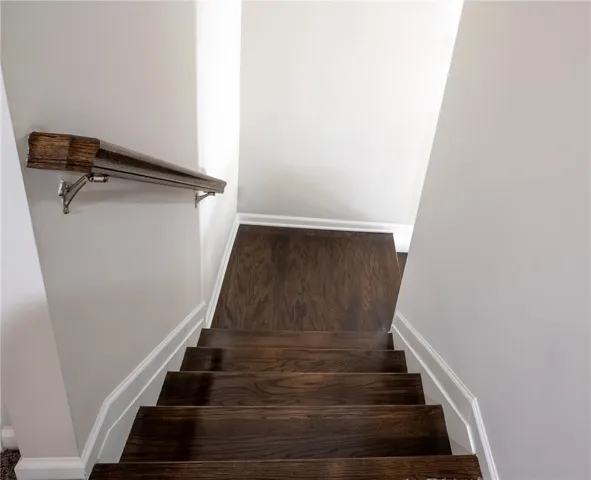 Clean lines and rich wood stairs create an inviting passage between levels.