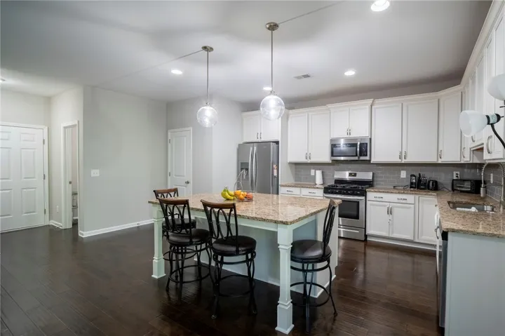 This spacious culinary haven offers abundant counter space and gleaming appliances for effortless entertaining.