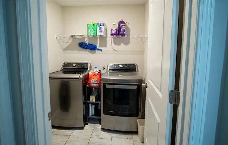 This dedicated utility room offers convenient laundry solutions with practical storage.