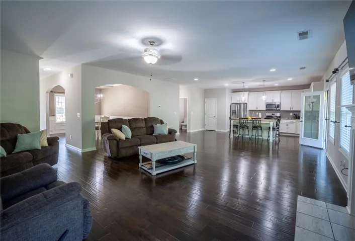 This expansive open concept space offers seamless transitions between living, dining, and kitchen areas.