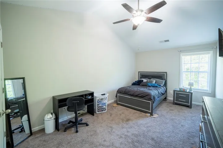 Bright and airy bedroom with plush carpet and ample natural light.
