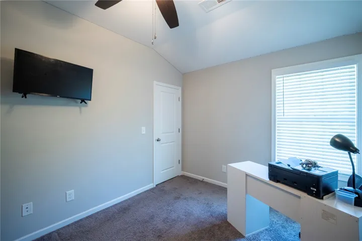 This cozy room offers vaulted ceilings and a bright window, perfect for a peaceful retreat or home office.