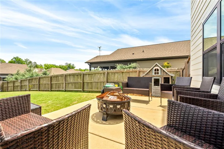 This spacious patio and yard offer an ideal setting for outdoor gatherings and entertaining.
