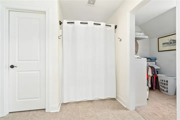 This organized walk-in closet offers ample storage and easy access to your wardrobe essentials.
