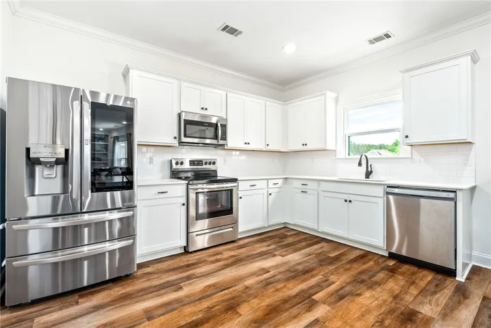 This spacious kitchen offers ample cabinet space and modern stainless steel appliances.