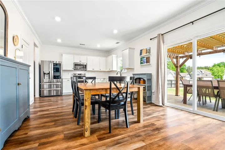 This bright kitchen offers modern appliances and seamless access to outdoor living.