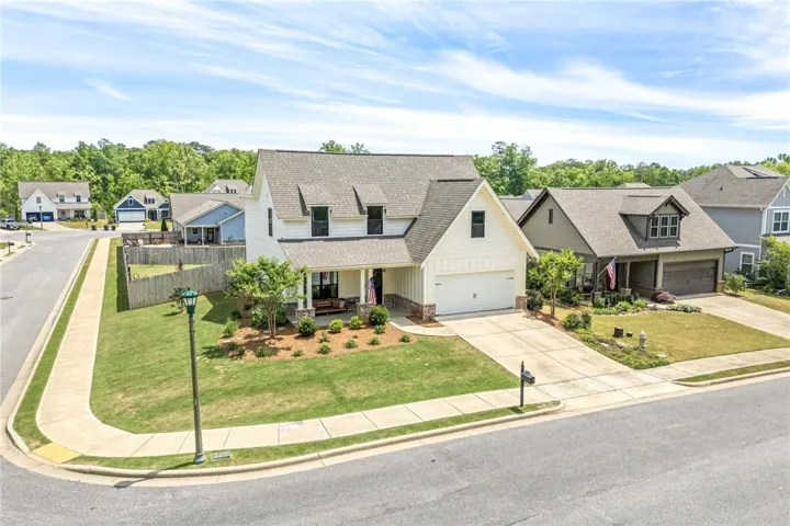 This charming suburban residence features a well-maintained lawn and a welcoming front porch.