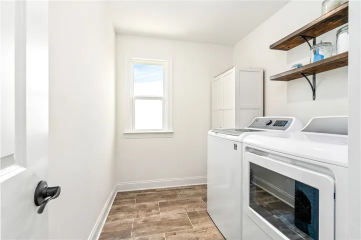 This bright utility room features a window for natural light and ample space for laundry tasks.