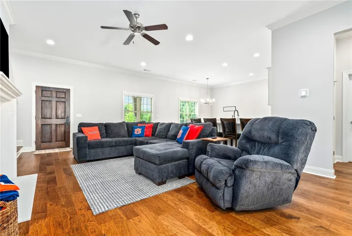 This inviting living area boasts rich hardwood floors and abundant natural light, perfect for everyday living.