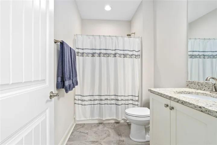 This clean and inviting bathroom features modern fixtures and ample natural light.