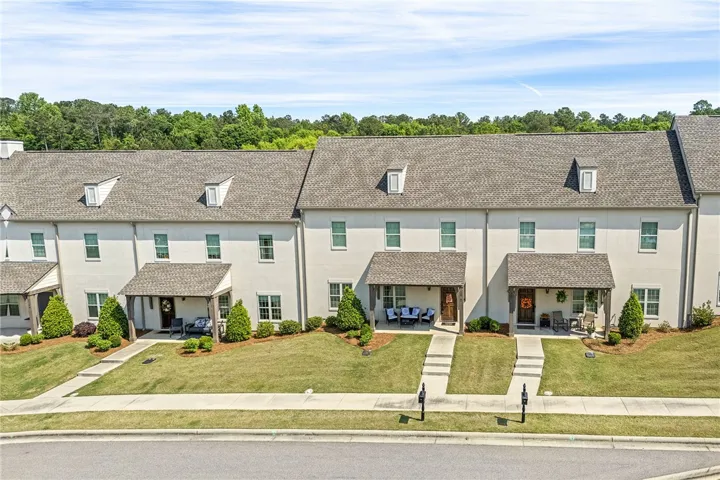 These charming townhomes feature welcoming porches and manicured lawns, offering comfortable living.