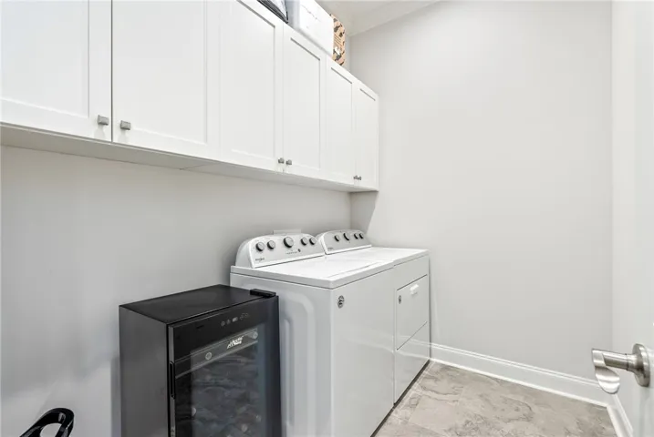 This dedicated laundry space combines efficiency with ample storage.