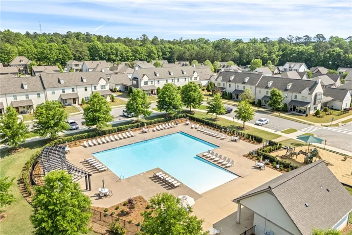 An inviting community pool and playground await in this vibrant residential neighborhood.