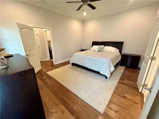 This spacious bedroom offers high ceilings and beautiful hardwood flooring.