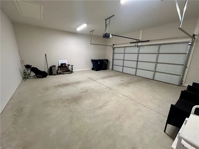 This spacious garage offers ample storage and direct home access.