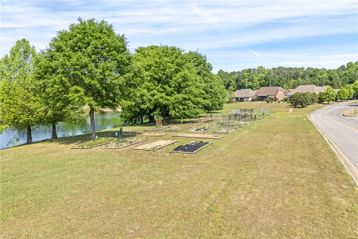 This verdant garden lot offers serene waterfront living and community amenities.
