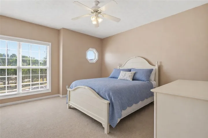 This cozy bedroom offers a tranquil retreat with soft lighting and expansive window views.
