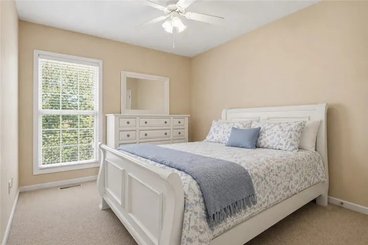 This inviting bedroom offers comfort and a tranquil escape.