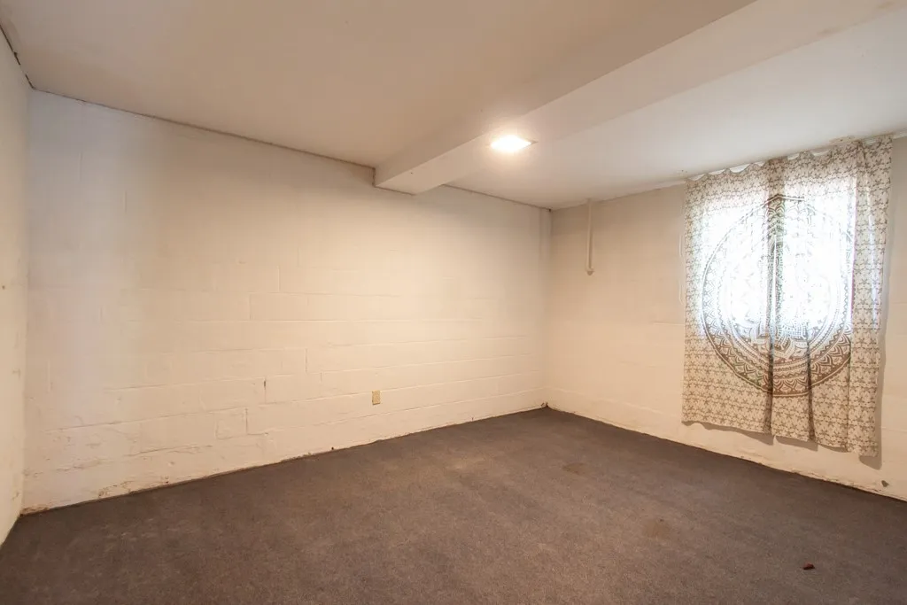 This spacious basement offers a versatile area for various uses.