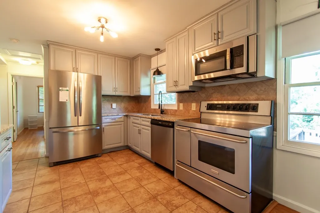 This functional kitchen features ample cabinetry, durable countertops, and essential appliances for daily living.